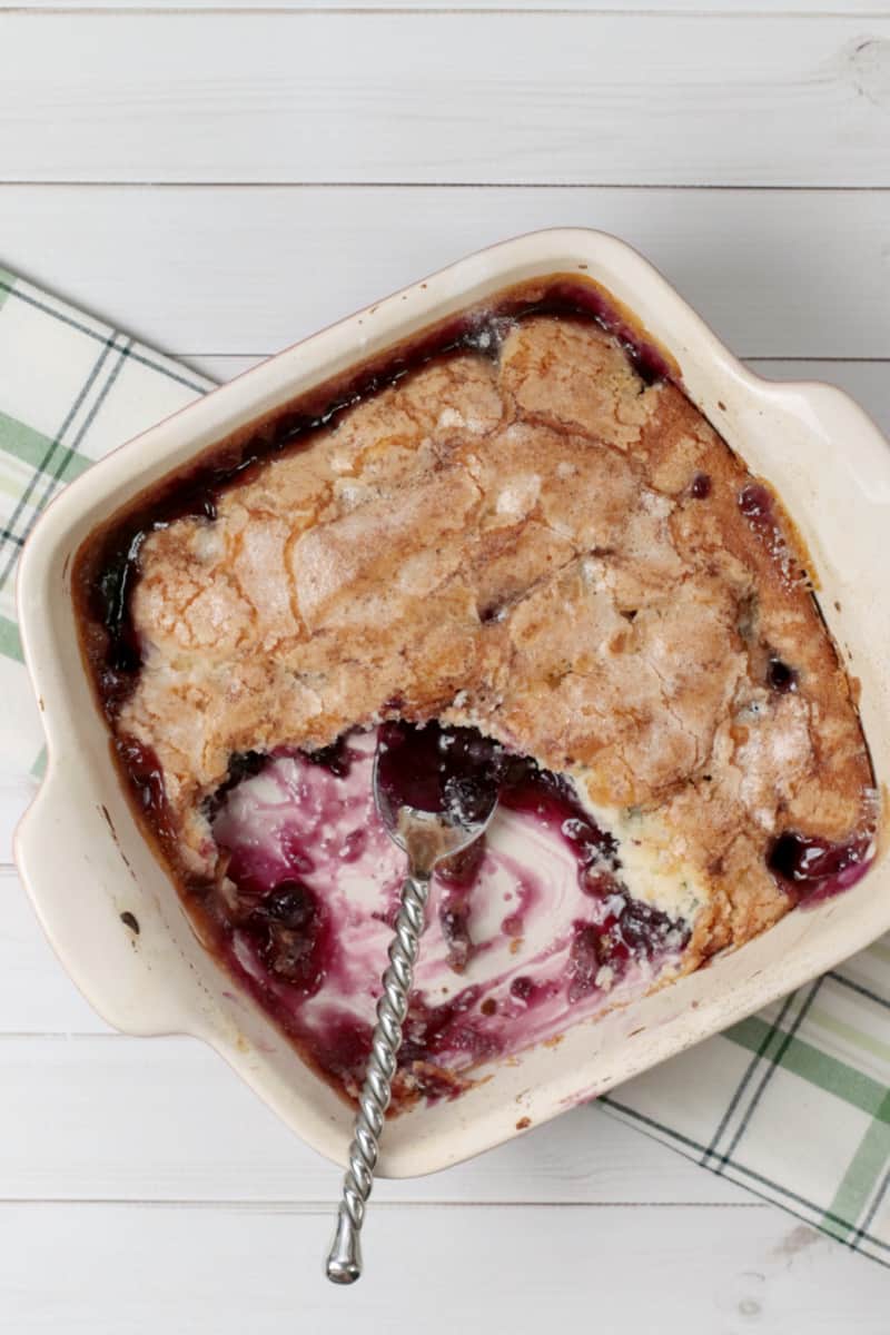 a pan of blueberry cobbler with a spoon