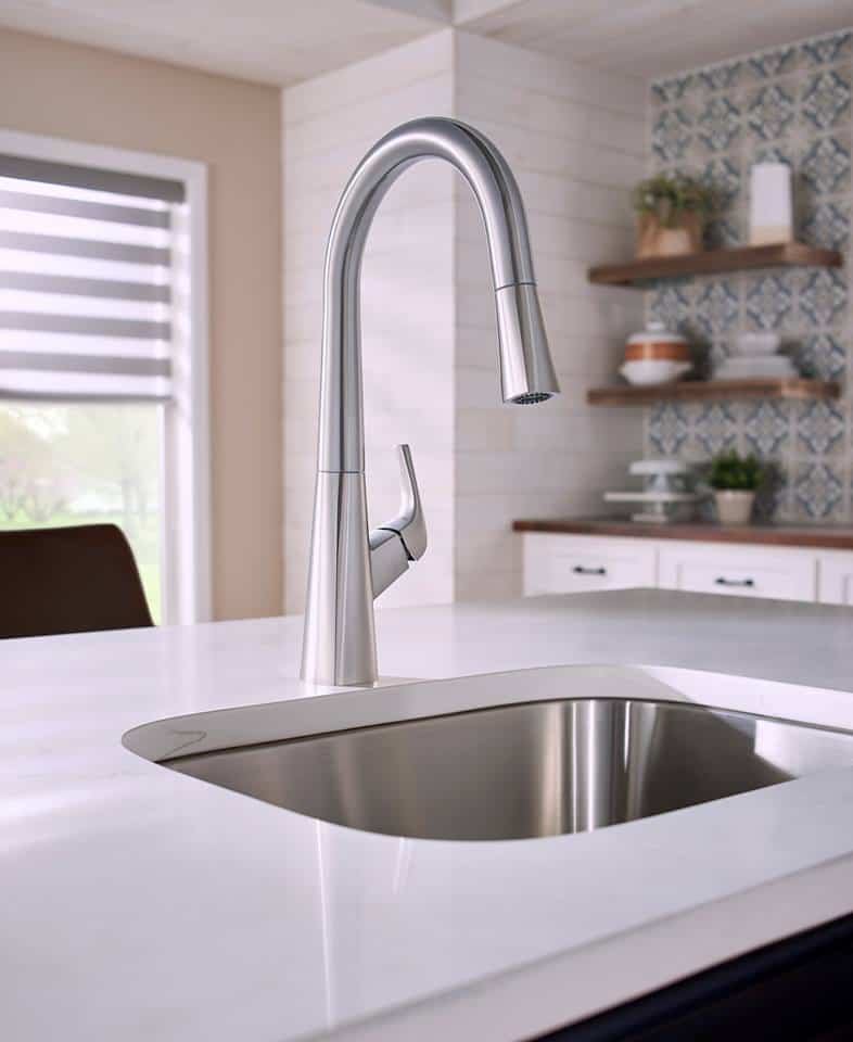 a chrome color touch kitchen faucet and a white counter top