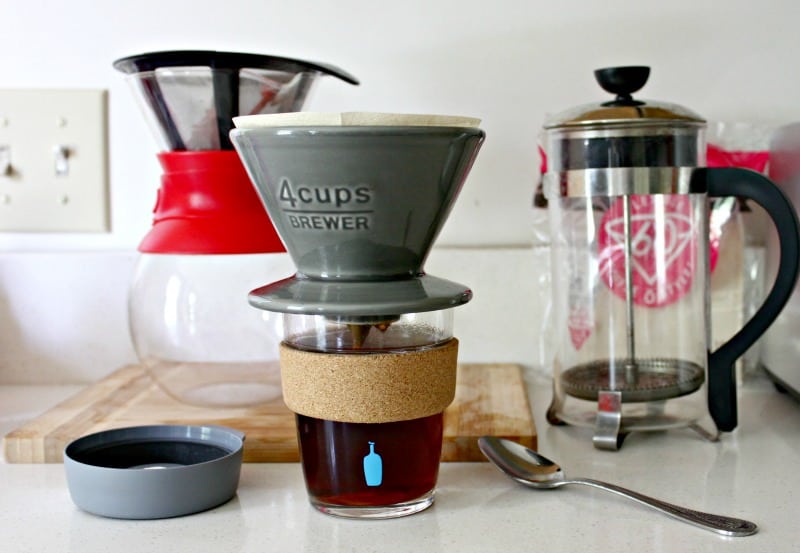 French press, pour over, a mug and a spoon on the counter