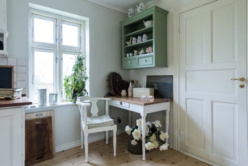 a farmhouse kitchen beautifully decorated in green and white