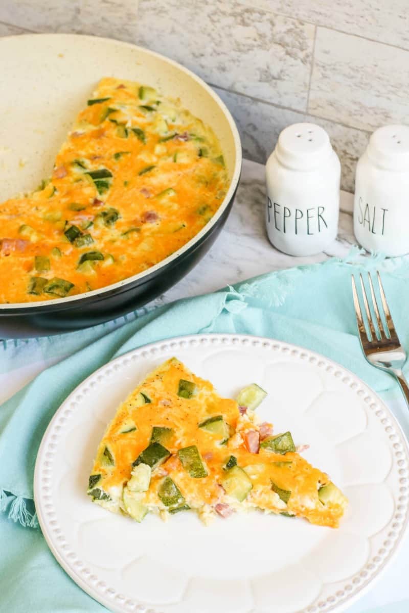 a frittata with zucchini and ham on a plate