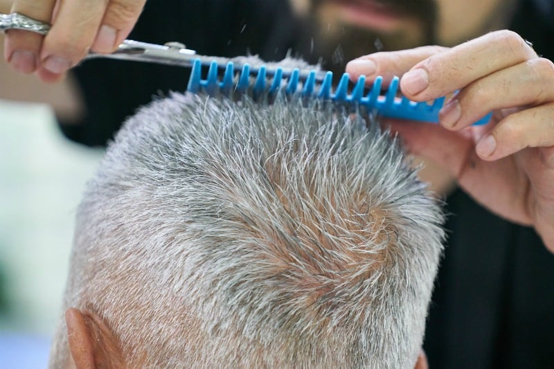a man having his hair trimmed