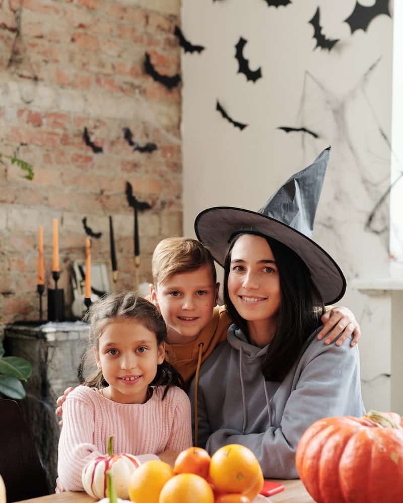 a family with homemade Halloween costumes sitting at the table