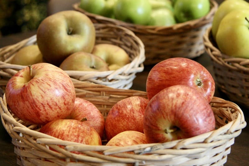 baskets filled with different types of apples