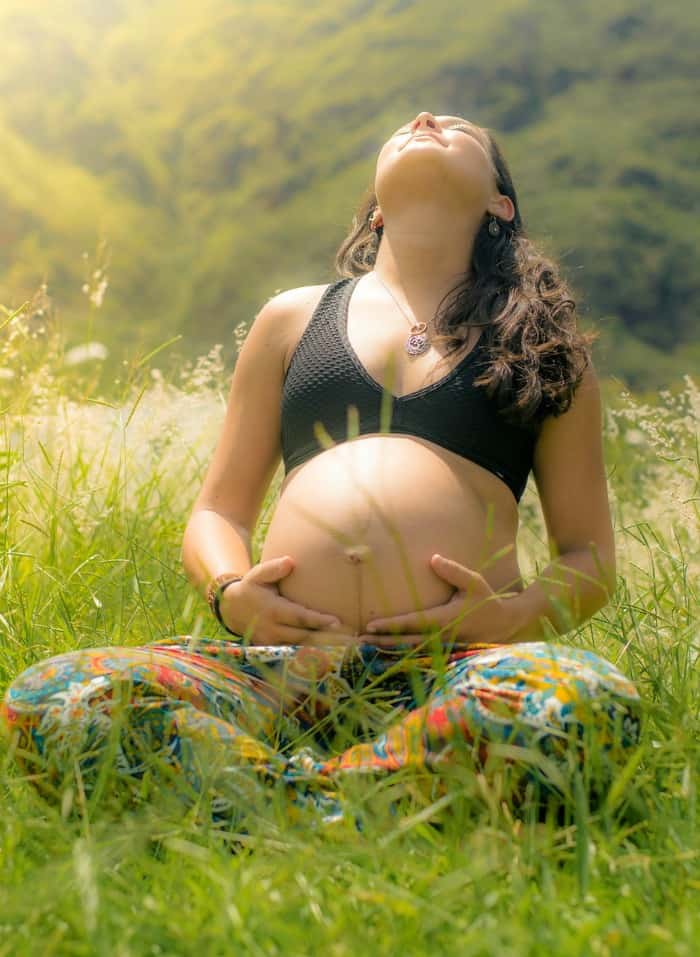 pregnant woman outside in the grass