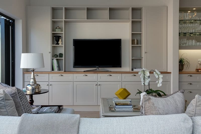 a room with a large screen television and entertainment center