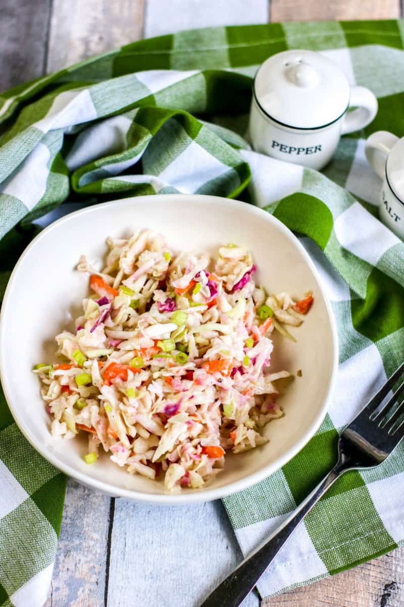 a bowl of Weight Watchers Coleslaw in a white bowl near a green and white towel