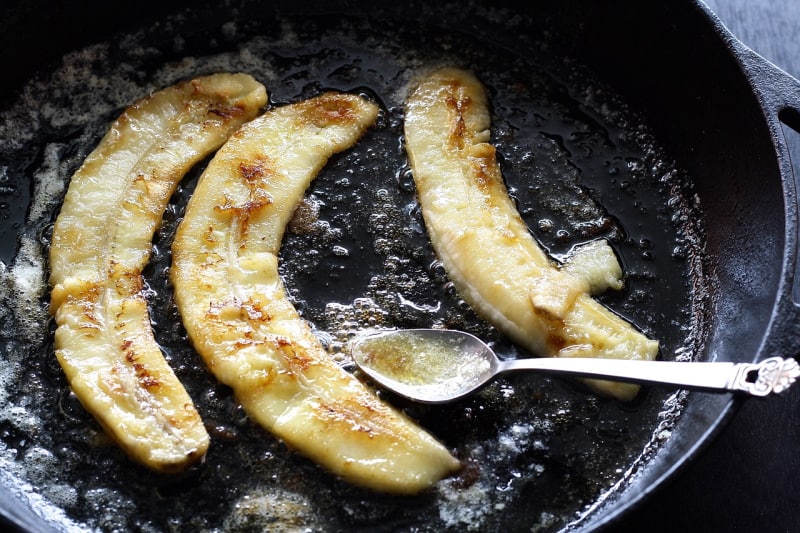 making bananas foster in a cast iron pan