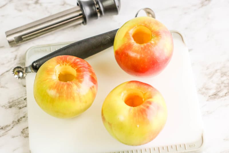 cored apples on a white cutting board