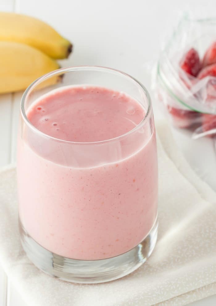 a strawberry smoothie with bananas on the table