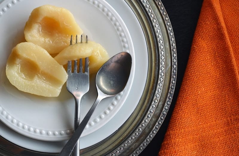 fruit on a while plate with cutlery