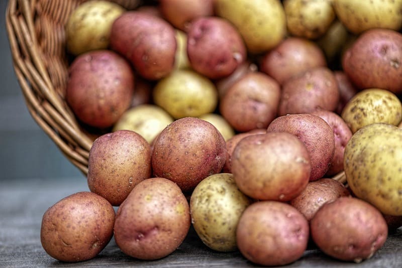 potatoes spilling out of a bucket
