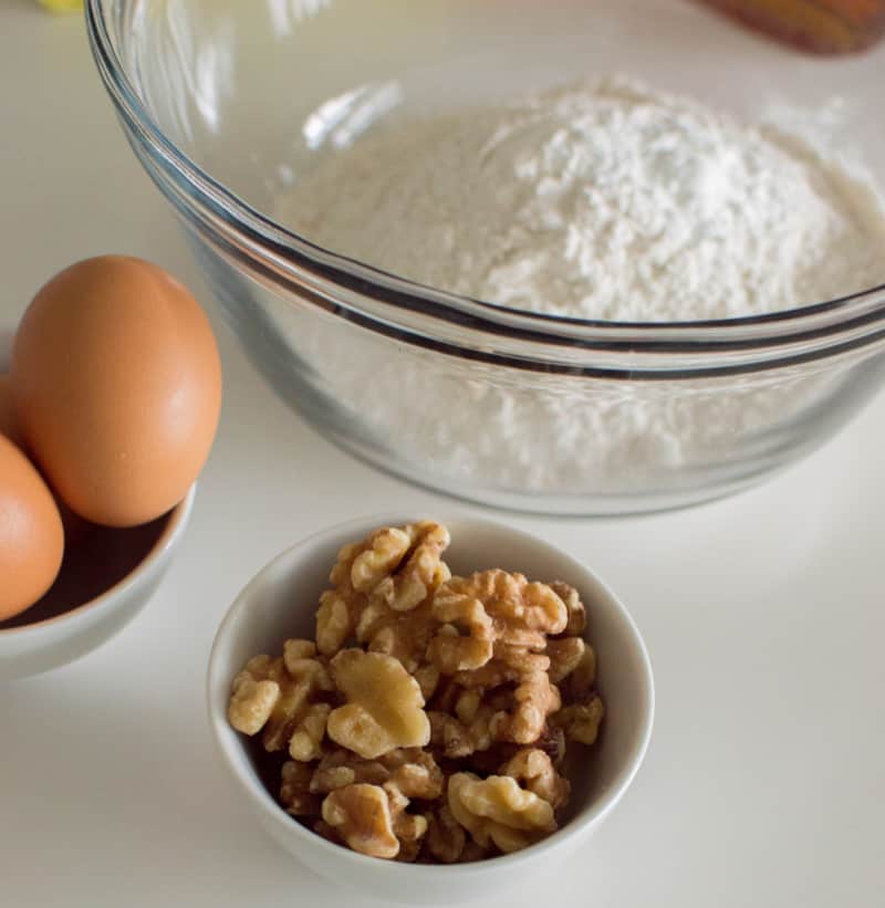 flour, nuts and eggs in bowls