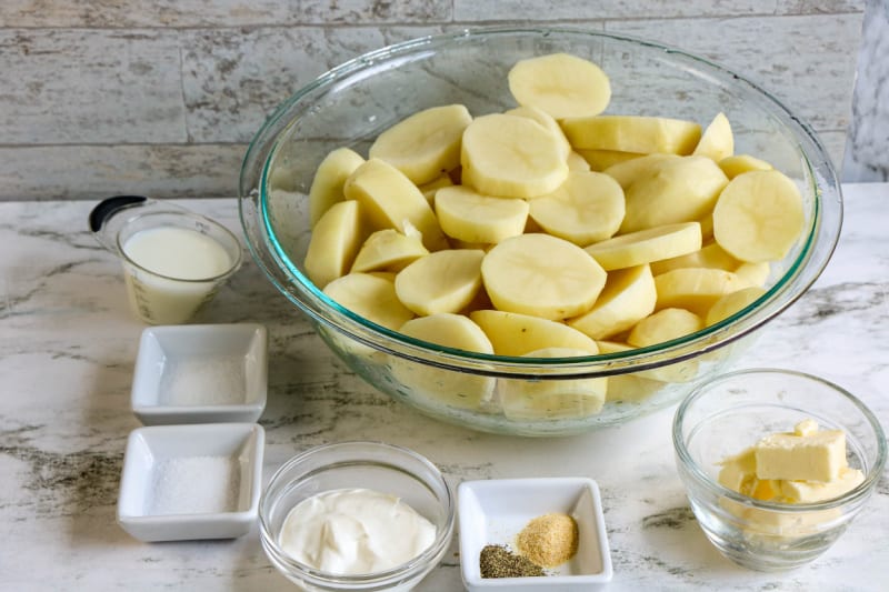 ingredients to make mashed potatoes in glass bowls