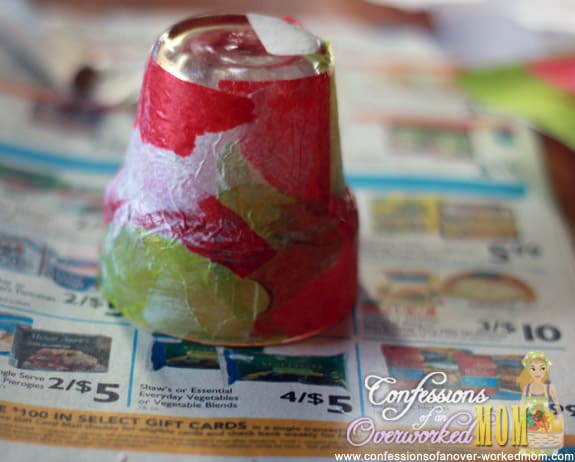 a Christmas candle holder being decoupaged
