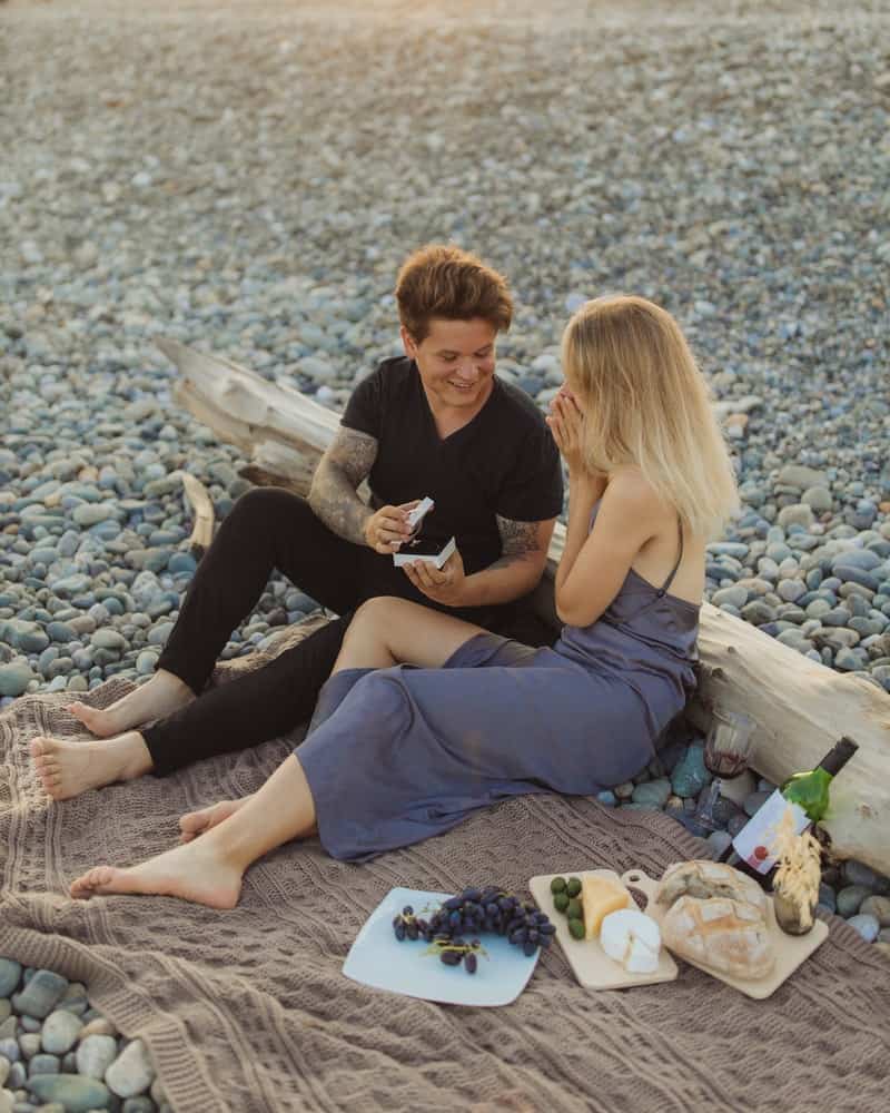 a couple having a romantic picnic on the beach