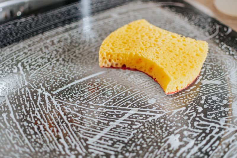 a sponge on a soapy surface for cleaning