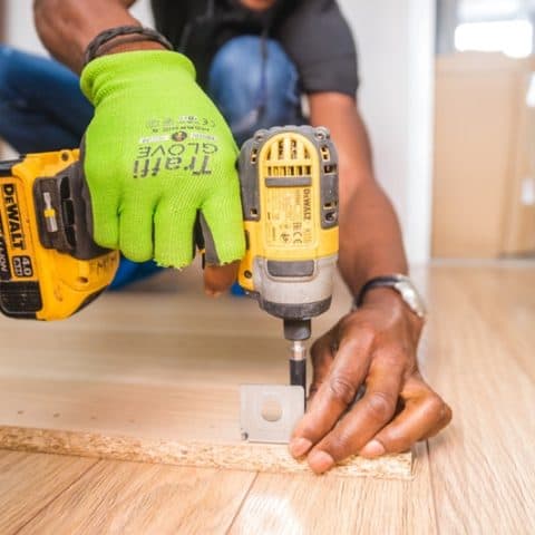 a man using a drill on wood