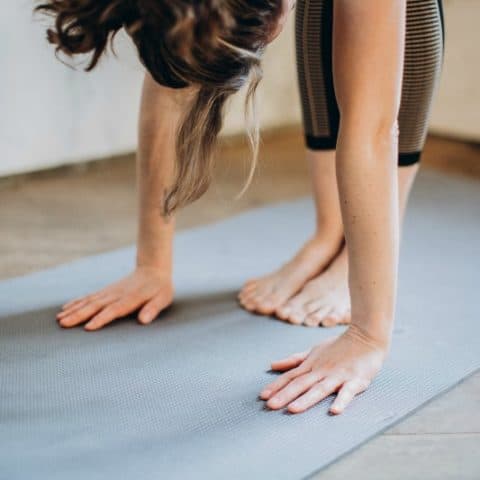 woman exercising on a yoga mat