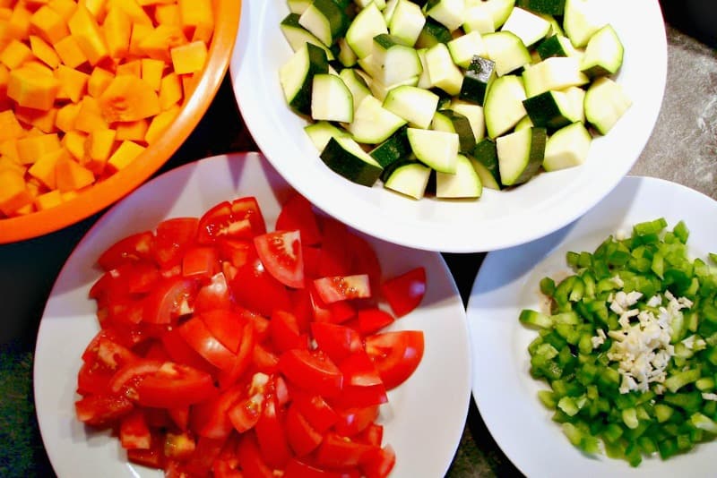 white bowls with chopped fresh vegetables