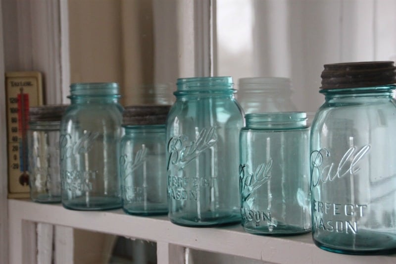 a row of Mason jars in the pantry
