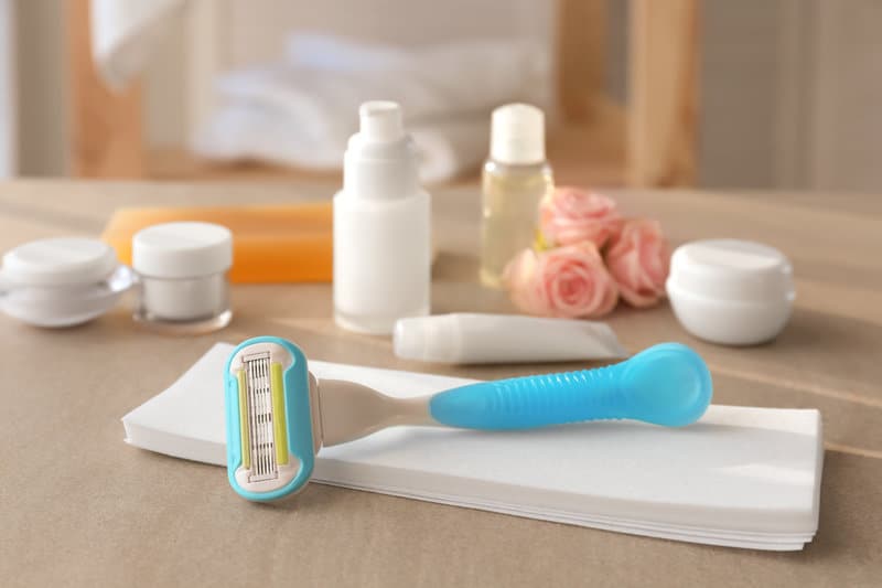 a razor and beauty products on a table