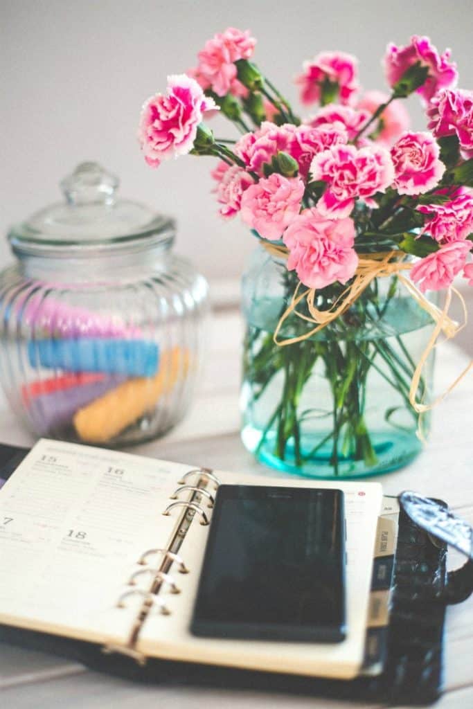 planner and flowers on a desk