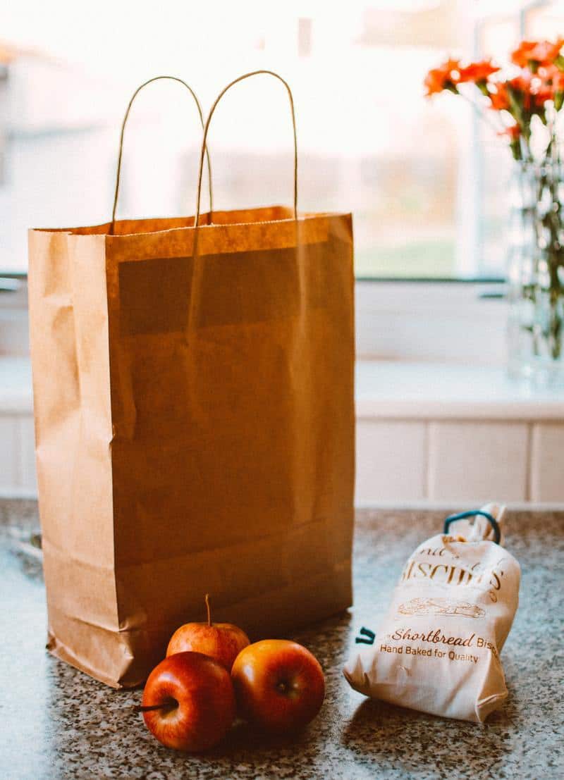 a paper bag with groceries
