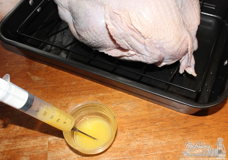 drawing liquid into a flavor injector near a whole turkey