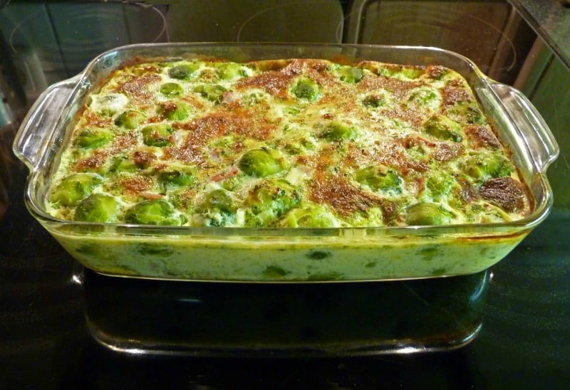 a baking dish in the oven with a creamy sauce