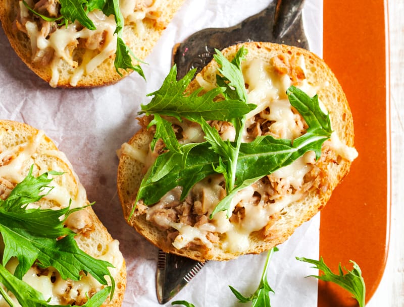 This open faced tuna melt is made with homemade bread, topped with cheddar cheese and garden greens. Try the best open faced tuna melt today.