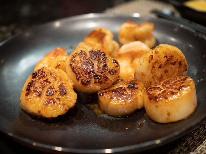 a plate with seared scallops on it