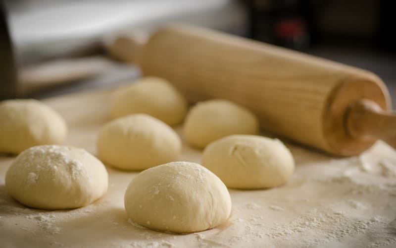 bread dough containing soy lethicin with a rolling pin