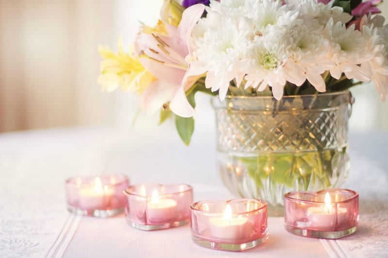 flowers in a crystal vase and candles