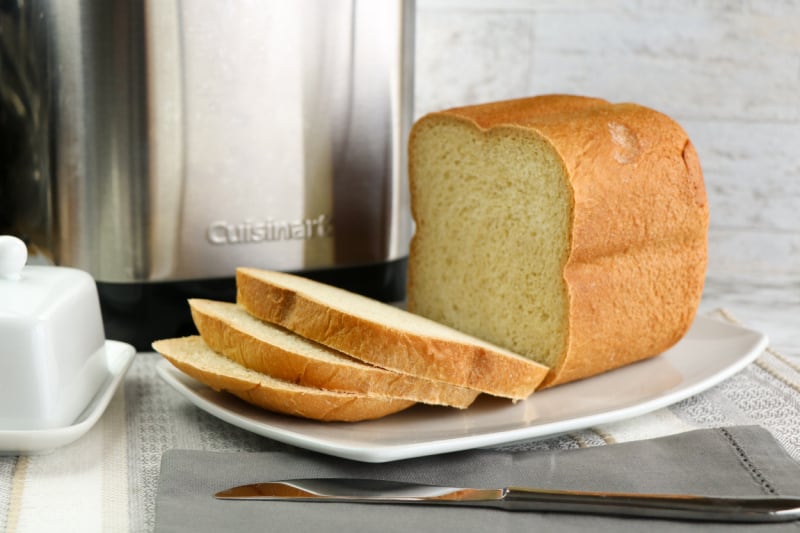 a loaf of bread sliced on a white plate