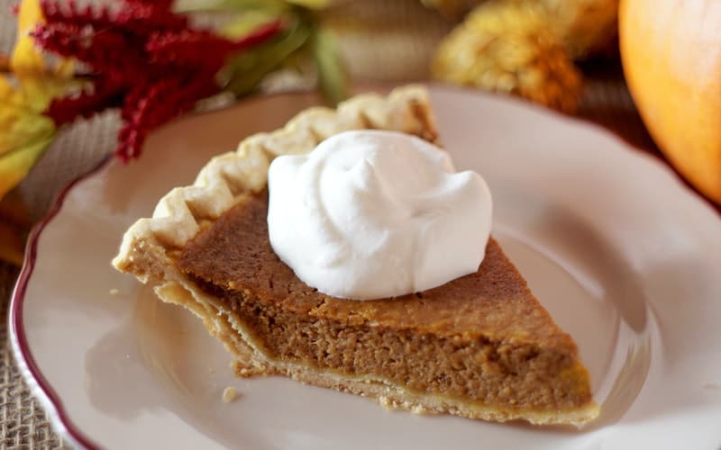 a slice of pumpkin pie with whipped cream