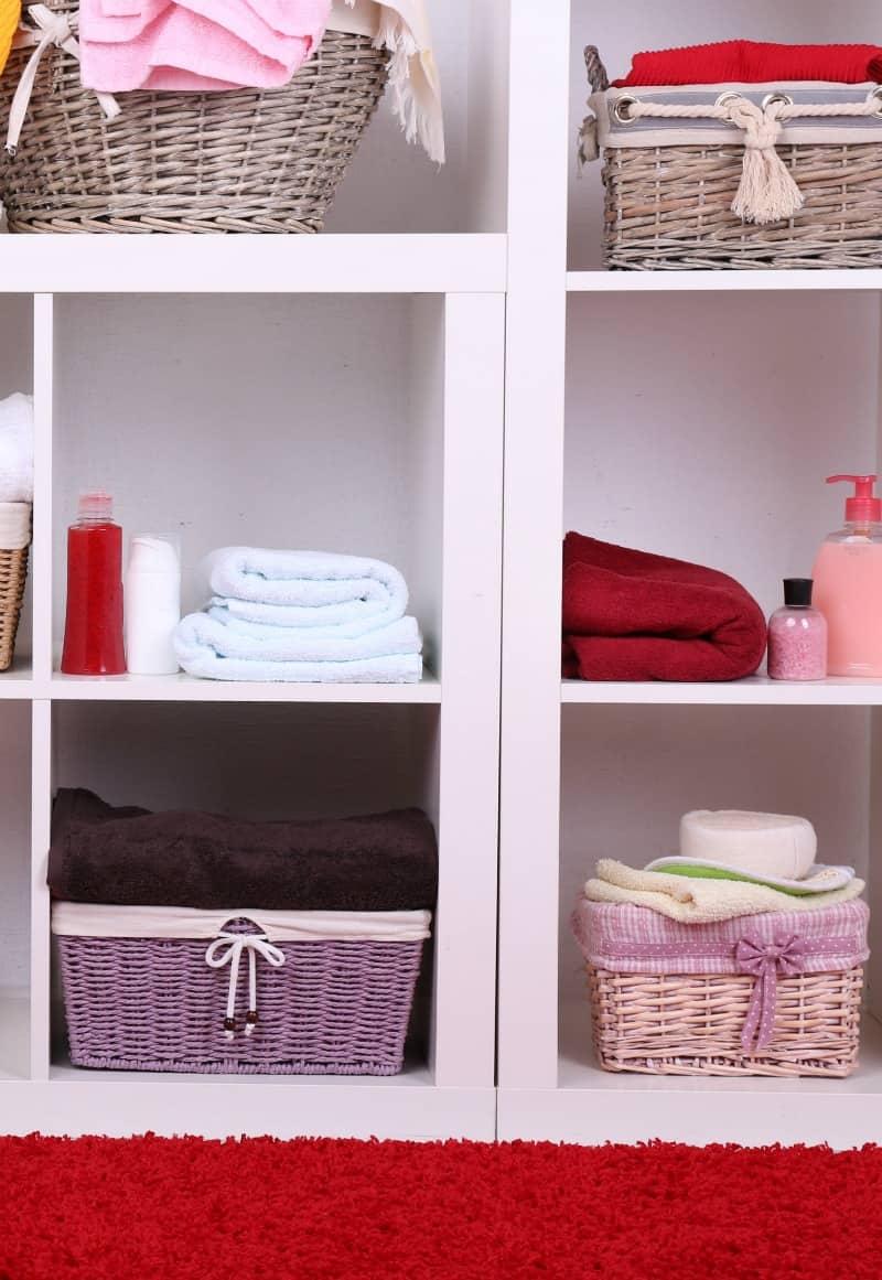 towels on shelves in the bathroom