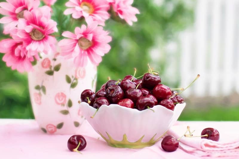 Fresh cherries in a pink bowl
