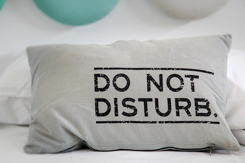 a pillow that says do not disturb on it