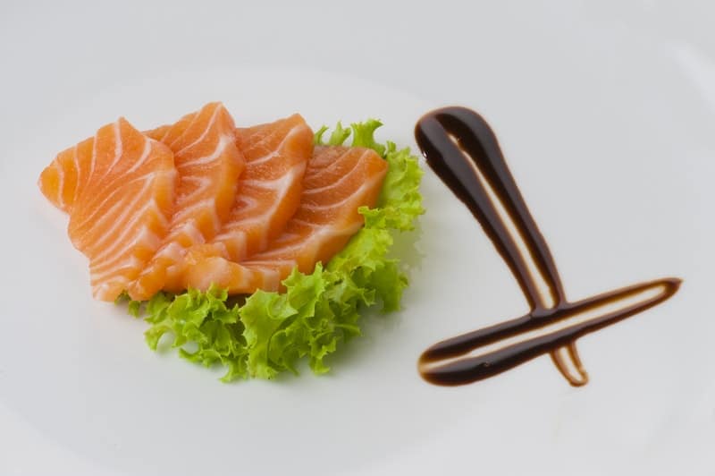 salmon and lettuce on a white plate