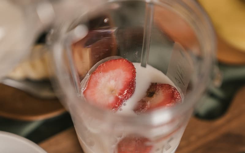 a blender with strawberries in it