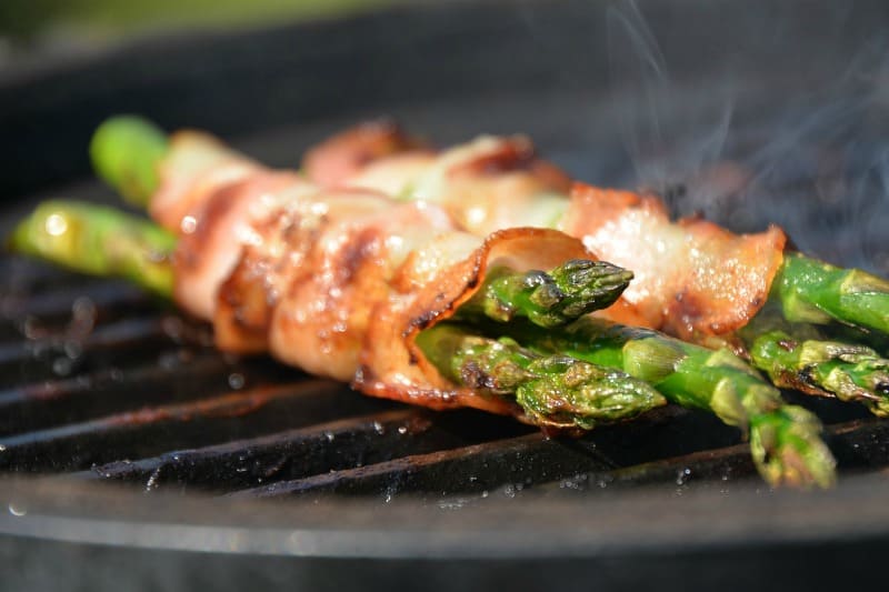 asparagus wrapped in bacon on a grill