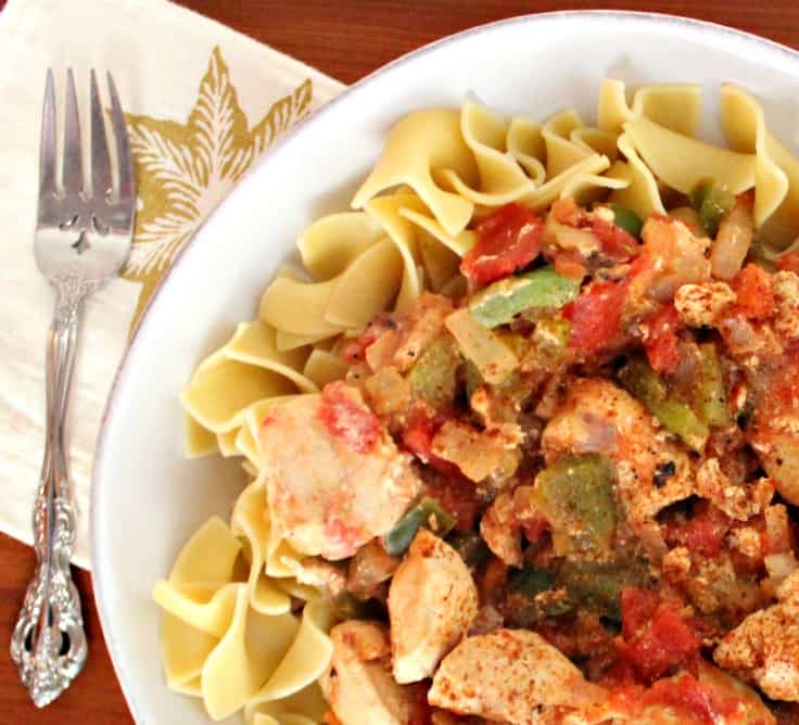 chicken and tomatoes with peppers over noodles