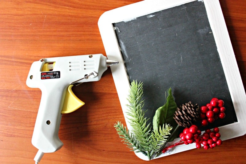 adding decorations to a Christmas chalkboard