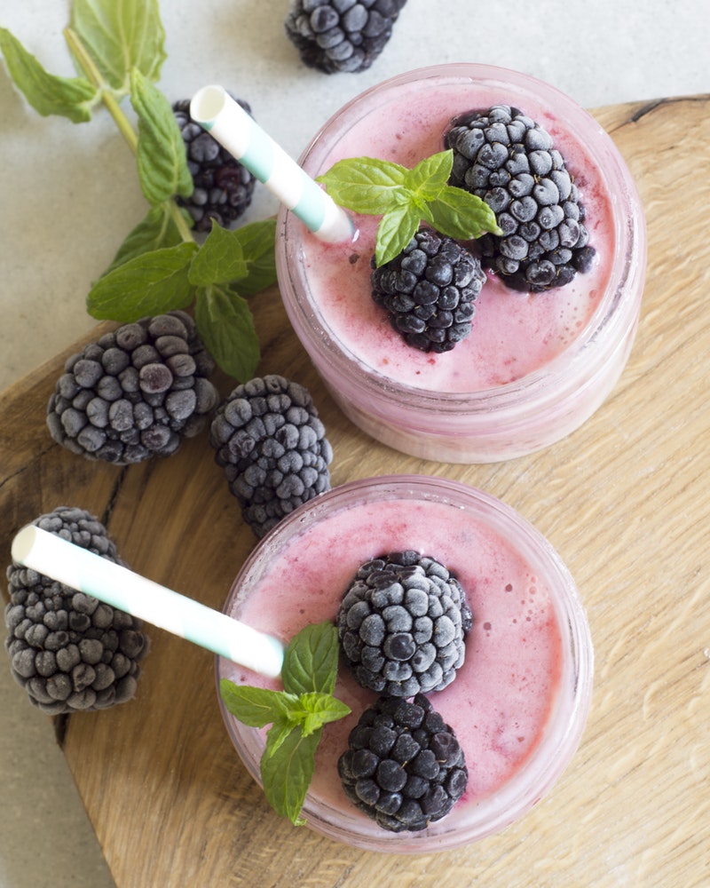 berry smoothies topped with frozen blackberries