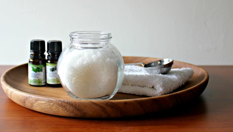 a jar of sinus relief salts with essential oils on a wooden tray