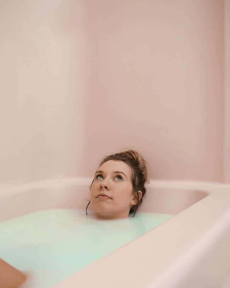 a woman taking an Irish buttermilk bath in the tub