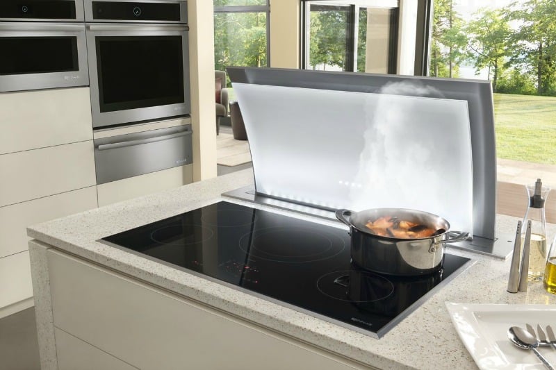 a flip top kitchen range with a pot boiling on it