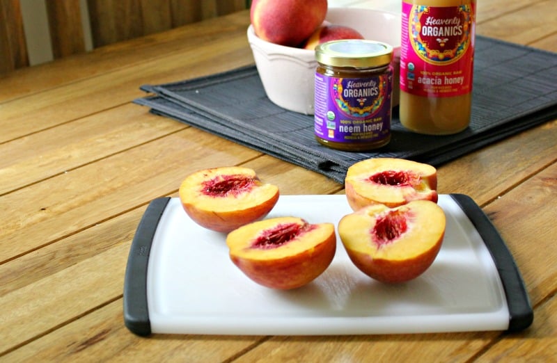 fresh peaches on a cutting board on a wooden tabler