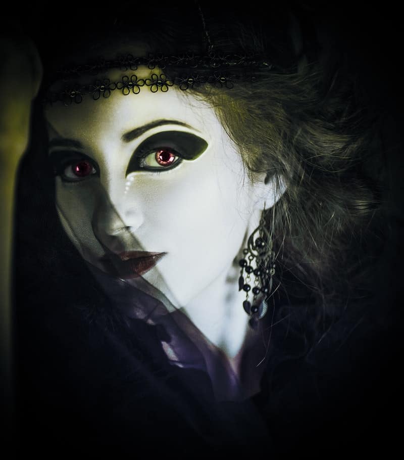 a female vampire with a white face and black eyes